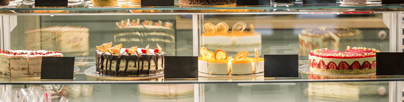 Interior of a cozy artisan bakery with fresh cakes and pastries.